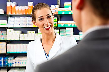 Female pharmacist consulting a customer in pharmacy
