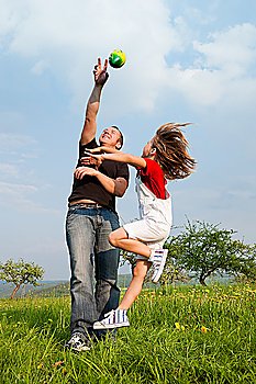 Family affairs - father and daughter playing football together