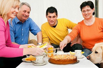 Family (parents and adult offspring) having coffee and cake together
