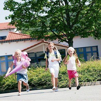 Three kids having fun at school running
