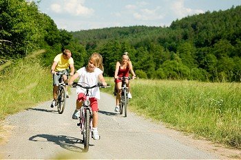 family with kids riding their bicycles 