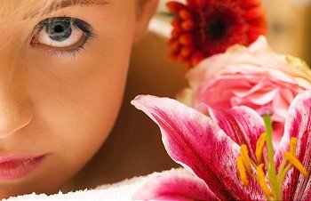 Girl with flowers in a spa situation feeling visibly good