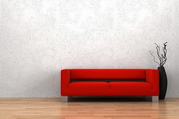 red sofa and vase with dry wood in front of white wall