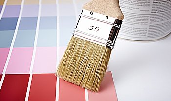 paint brush,  can and color samples, selective focus