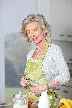 Closeup of smiling senior woman baking in kitchen