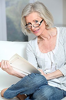 Portrait of senior woman reading book