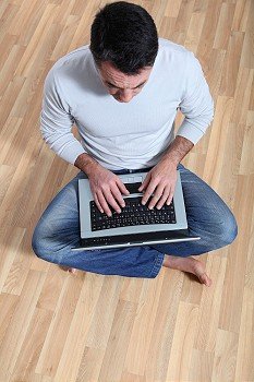 Man sitting on the floor with laptop computer