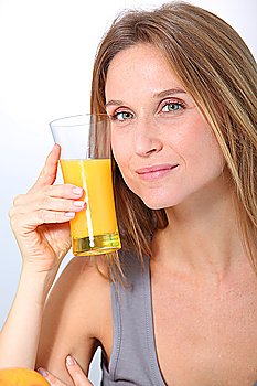Closeup of beautiful blond woman drinking fruit juice