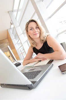 Businesswoman writing appointment on agenda