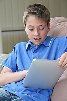Young boy using electronic tablet