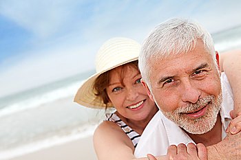 Portrait of happy senior couple on a sandy beach