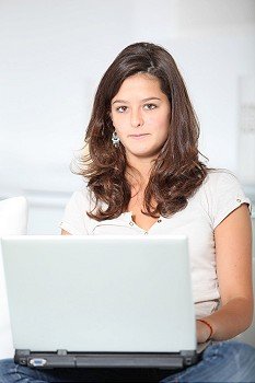Closeup of teenager girl with laptop computer