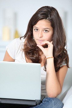 Closeup of teenager girl with laptop computer