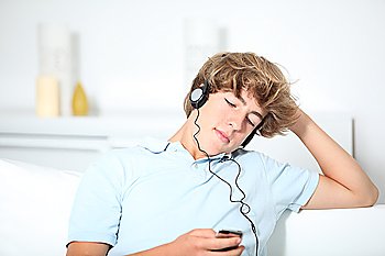 Teenager listeing to music in sofa