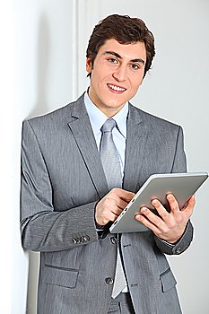 Businessman standing with electronic pad