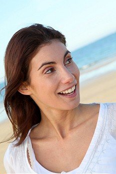 Portrait of beautiful smiling woman at the beach