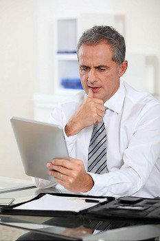 Portrait of businessman with electronic tab