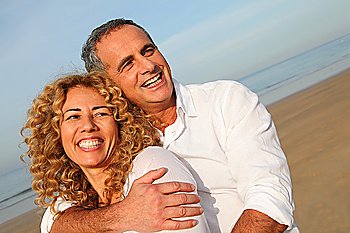 Portrait of happy mature couple at the beach