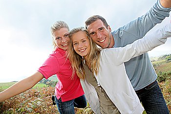 Happy family having fun in the countryside