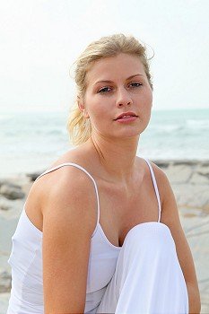 Closeup of beautiful blond woman relaxing by the beach