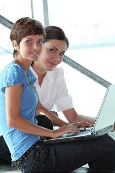 Young women working on laptop computer
