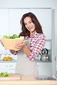 Beautiful woman stading in kitchen with apron