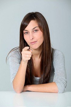 Young woman pointing at with finger