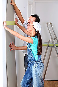 Young couple choosing color of wallpaper