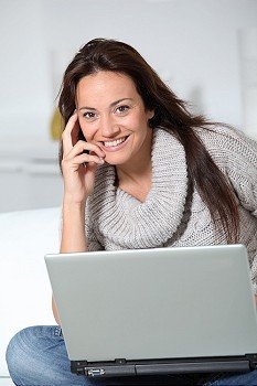 Woman on sofa with laptop computer