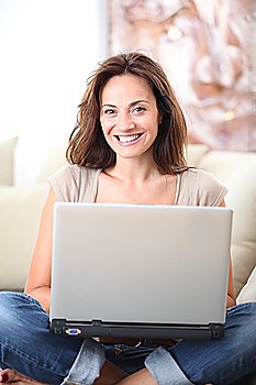 Woman on couch with laptop computer