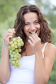 Closeup of woman eating grapes