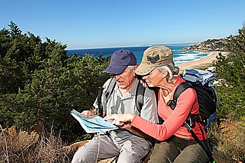 Senior couple looking at map on a rambling day