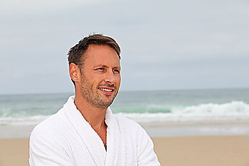 Man with bathrobe on the beach