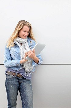 Blond woman using electronic tablet