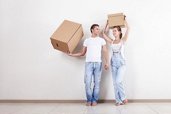 Attractive couple in the apartment with boxes