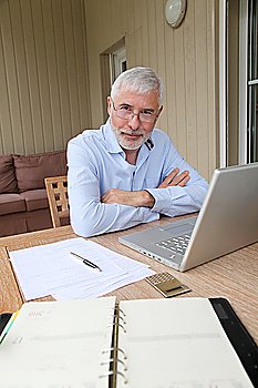 Senior businessman working at home