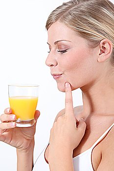Beautiful blond woman holding glass of orange juice