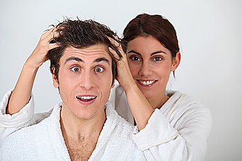 Young woman putting her hands in her boyfriend´s hair