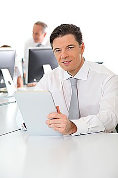 Office worker using electronic tablet in office