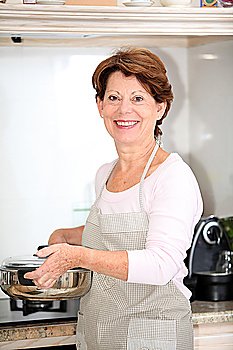 Closeup of senior woman standing in kitchen