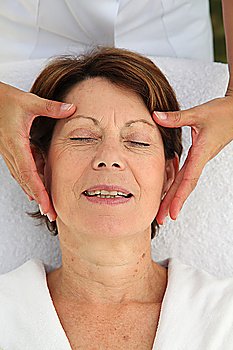 Senior woman having a face massage