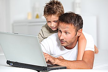 Father and son connected on internet at home