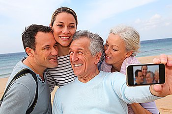 Family taking picture at the beach