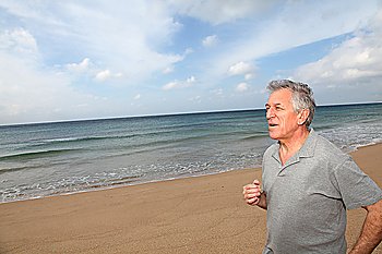 Senior man running on the beach