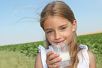Closeup of little girl drinking milk