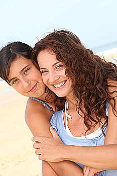 Closeup of mother and daughter at the beach