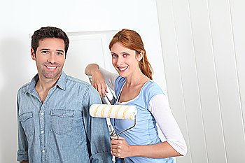 Couple painting new apartment