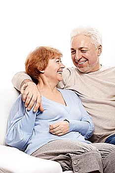 The family couple laughs on a white background