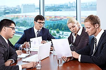 Business people discussing the growth of income at a table in the office