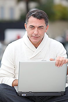 Man using laptop computer outside
